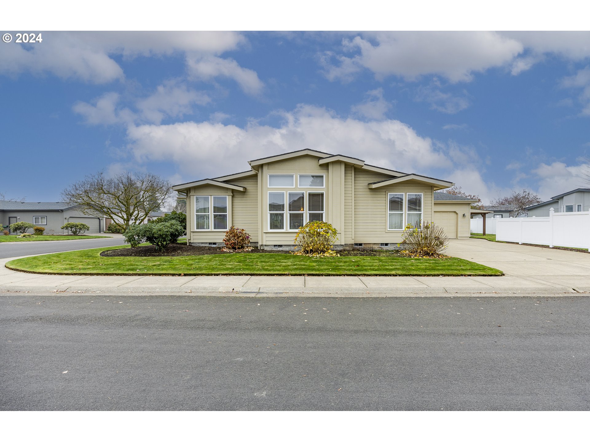 3220 Crescent Avenue, Unit 67 Eugene, OR 97408 - Photo 4 of 48 a front view of a house with a yard and garage