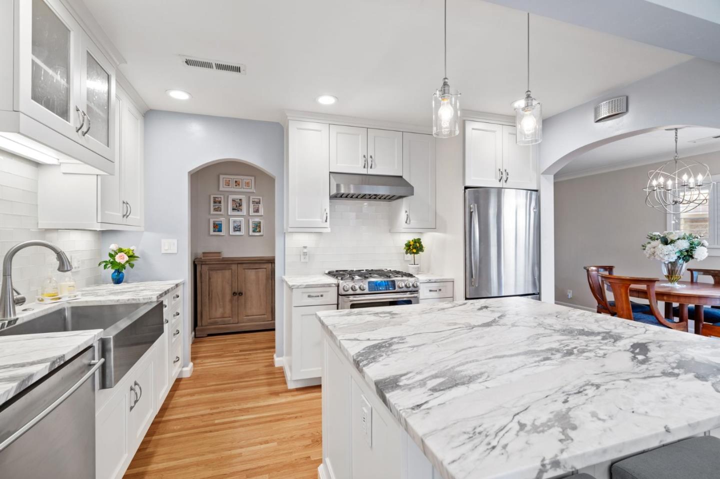 2428 Tulip Road San Jose, CA 95128 - Photo 20 of 59 a kitchen with stainless steel appliances kitchen island granite countertop a refrigerator a sink dishwasher a dining table and chairs with wooden floor