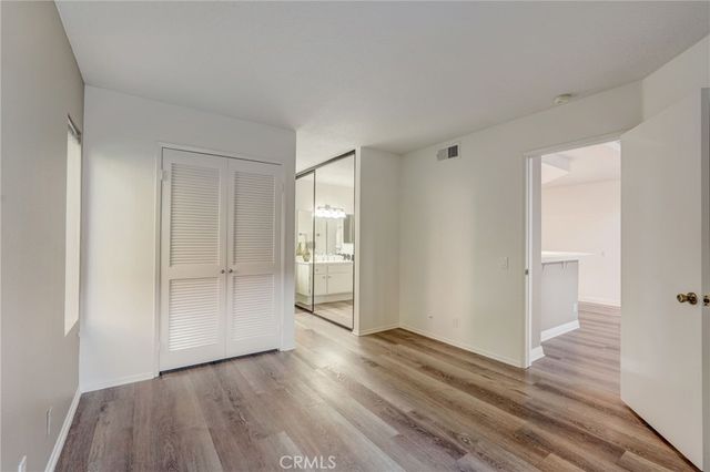 a view of wooden floor and windows in a room