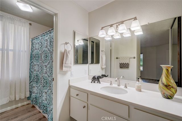 a bathroom with a sink vanity and a mirror