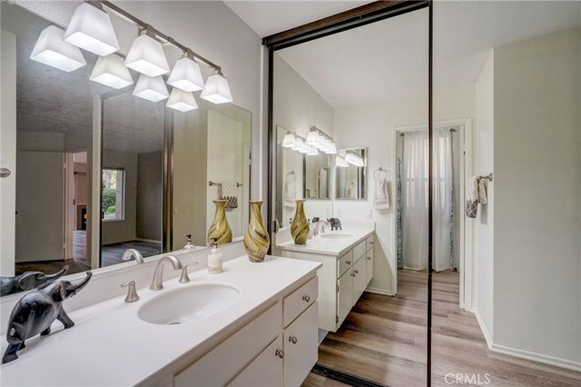 a spacious bathroom with a double vanity sink and a mirror
