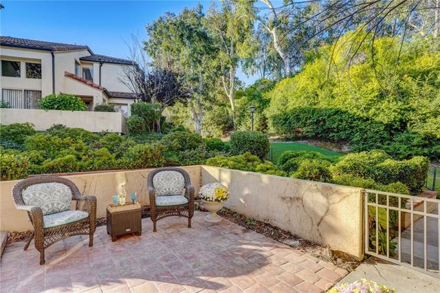 a view of a chairs and table in backyard