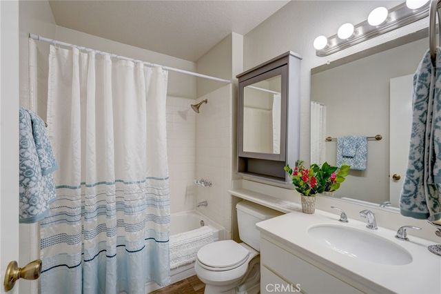 a bathroom with a sink toilet mirror and shower