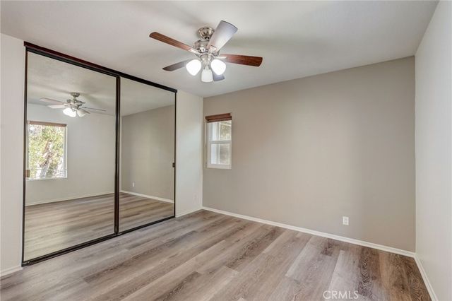 an empty room with wooden floor and mirror