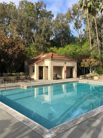 a front view of a house with swimming pool having outdoor seating