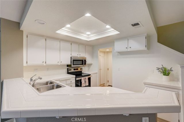 a kitchen with a sink a stove and refrigerator