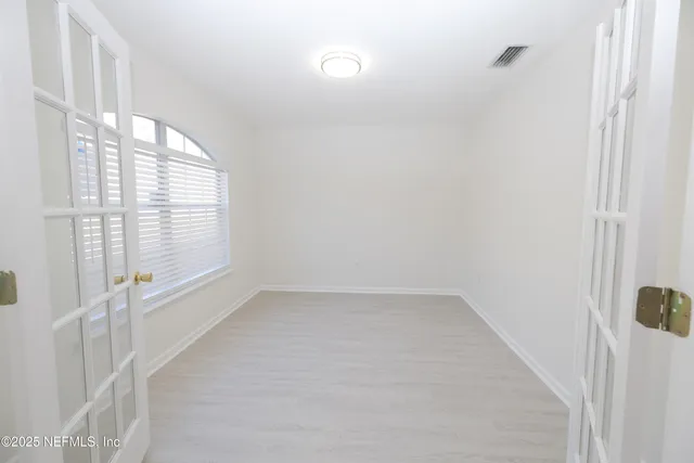 a view of an empty room with a window