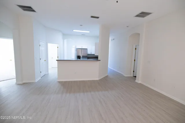 a view of a kitchen with a sink and a refrigerator