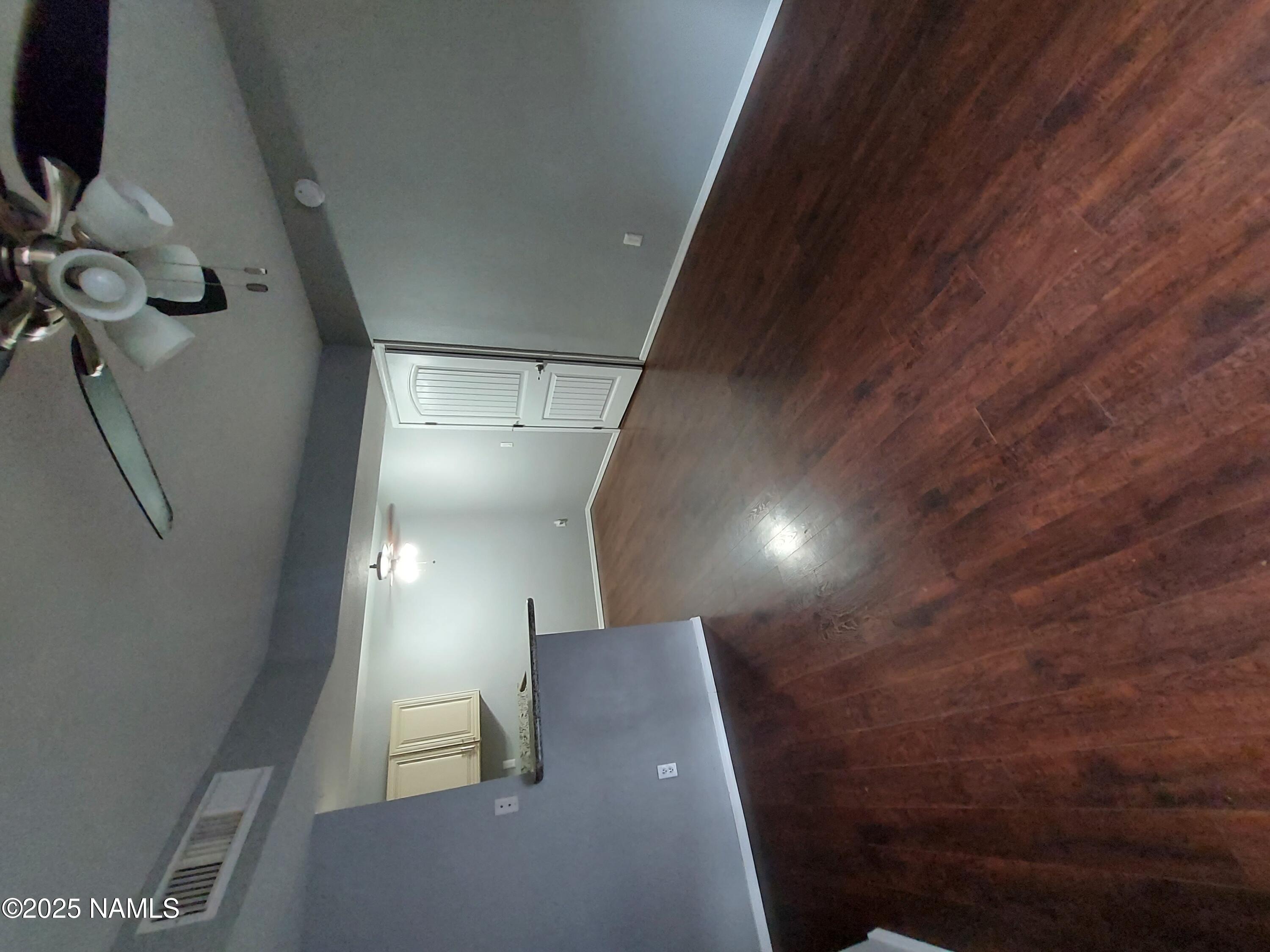 1385 West University Avenue, Unit 11181 Flagstaff, AZ 86001 - Photo 1 of 8 an empty room with wooden floor and windows