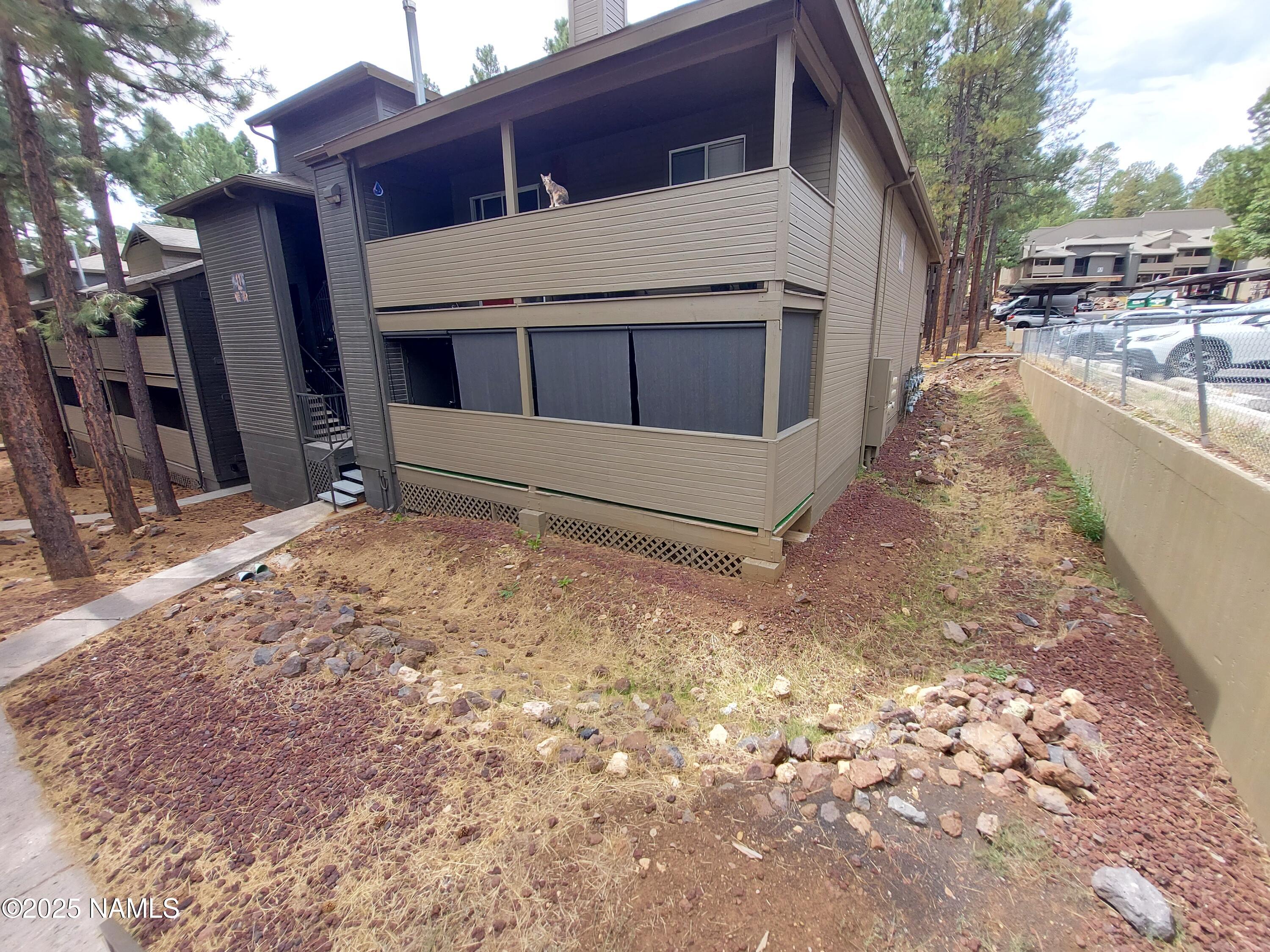 1385 West University Avenue, Unit 11181 Flagstaff, AZ 86001 - Photo 8 of 8 a view of a house with a yard