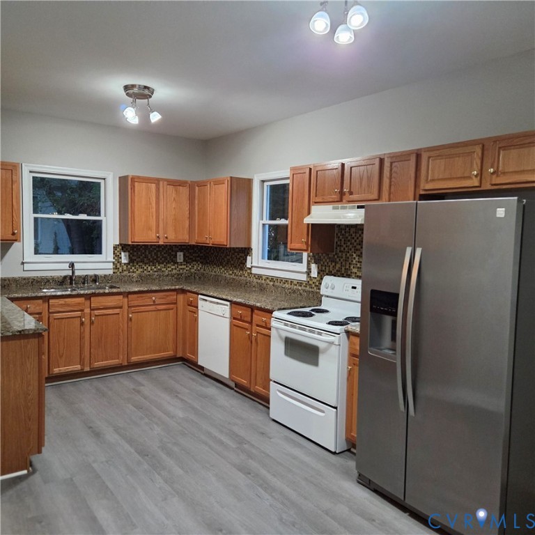 124 Lipscomb Street Richmond, VA 23224 - Photo 3 of 10 Kitchen featuring wood-finish cabinetry, speckled