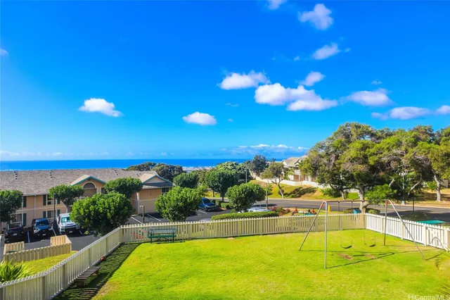 a view of a swimming pool with an outdoor seating and a garden