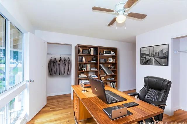 a living room with furniture a ceiling fan and a rug