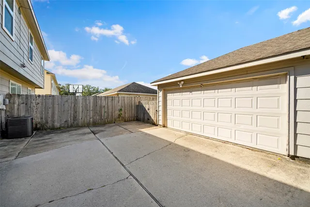 a view of a house with a backyard and wooden fence