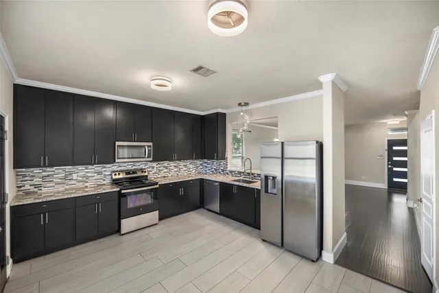a kitchen with stainless steel appliances granite countertop a sink and stove