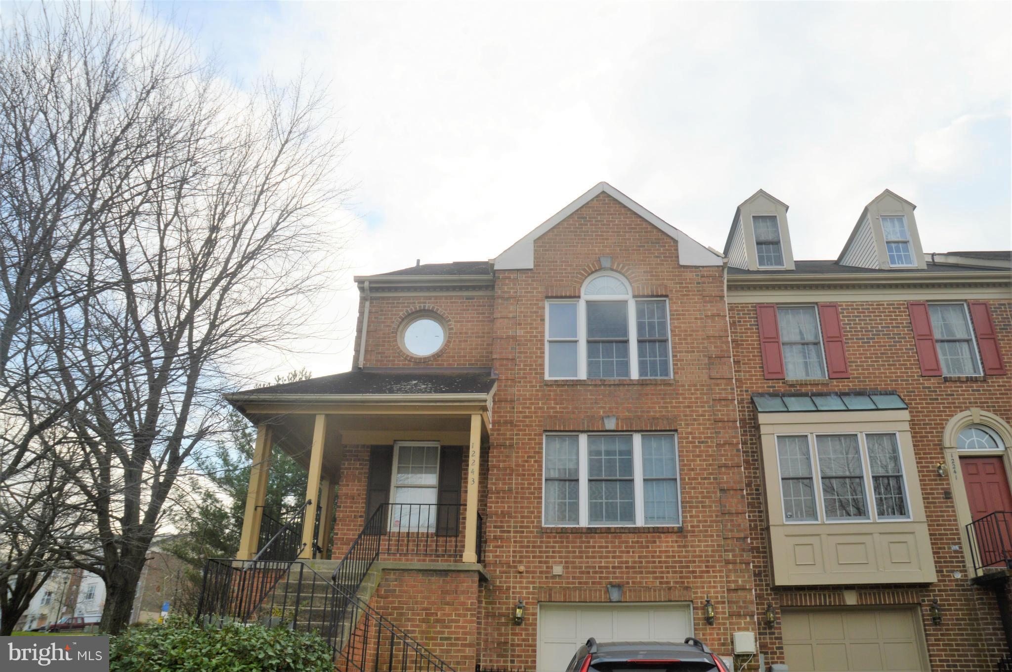 12243 Apache Tears Circle Laurel, MD 20708 - Photo 1 of 22 a view of a brick house with large windows and a large tree