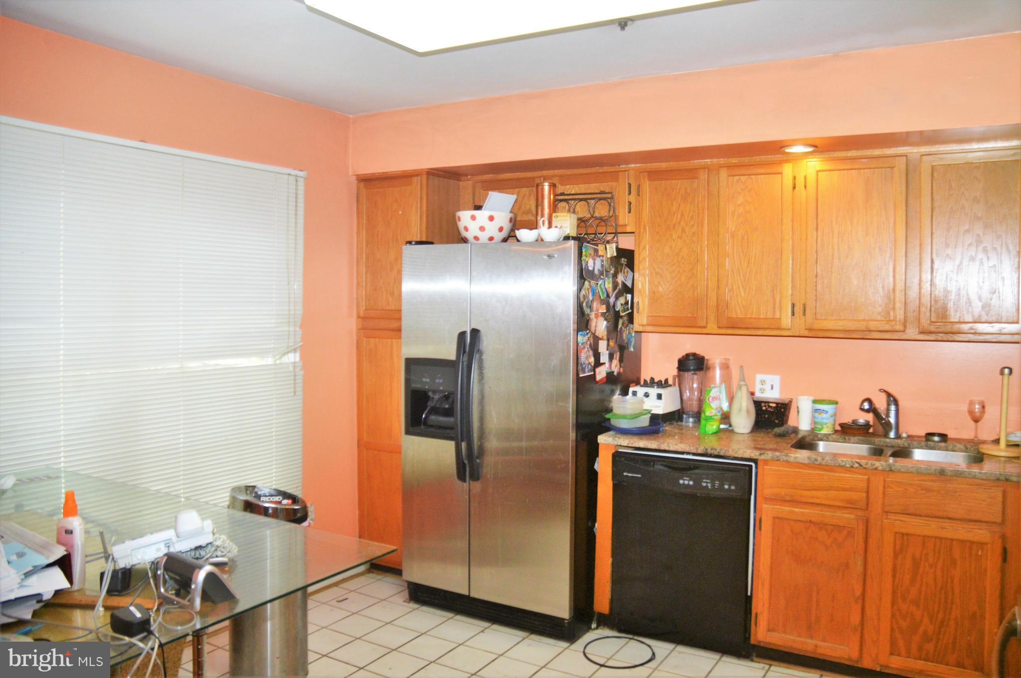12243 Apache Tears Circle Laurel, MD 20708 - Photo 18 of 22 a kitchen with stainless steel appliances granite countertop a refrigerator and a sink