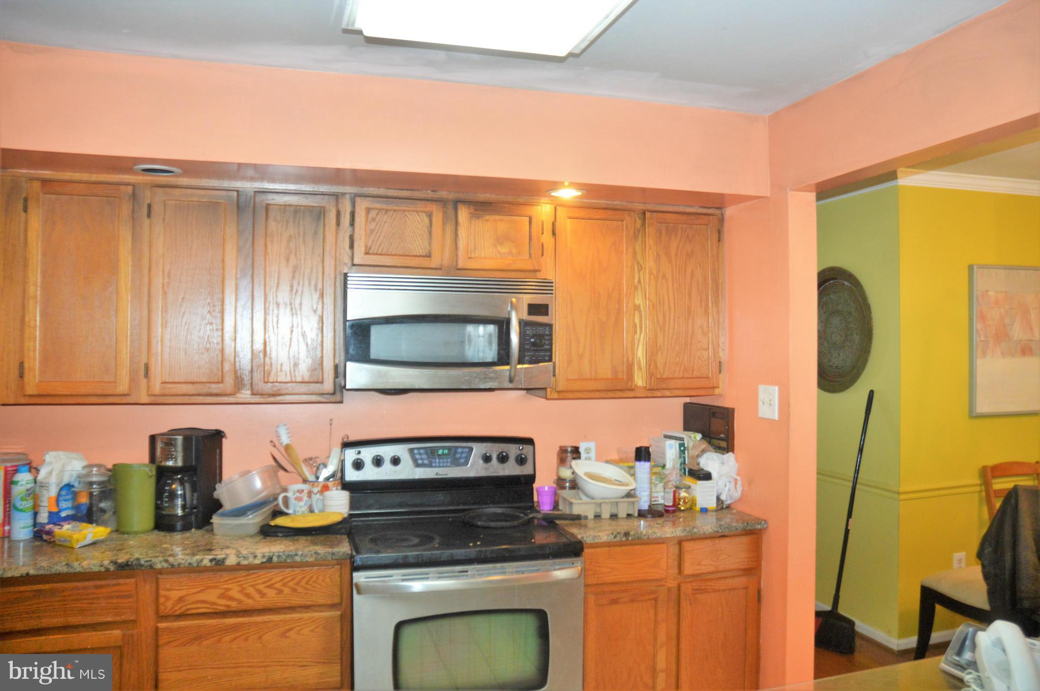 12243 Apache Tears Circle Laurel, MD 20708 - Photo 20 of 22 a kitchen with stainless steel appliances granite countertop a stove a sink and a microwave