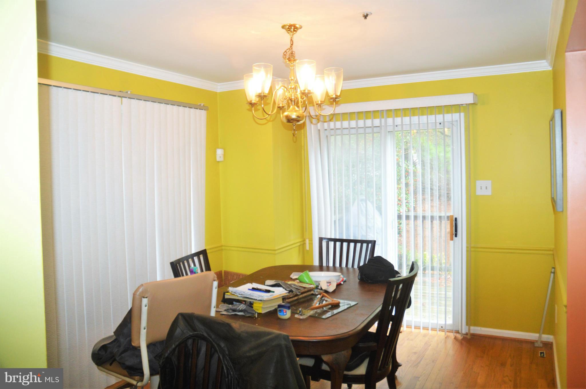 12243 Apache Tears Circle Laurel, MD 20708 - Photo 21 of 22 a view of a dining room with furniture and chandelier
