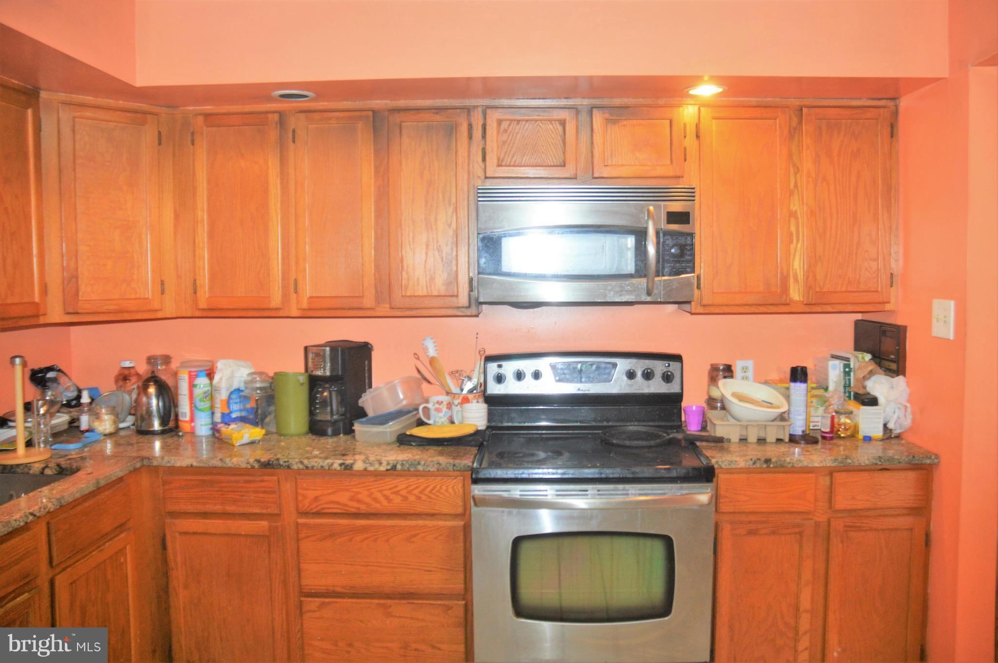 12243 Apache Tears Circle Laurel, MD 20708 - Photo 22 of 22 a kitchen with a stove and cabinets
