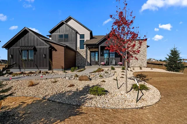 a view of a house with snow on the side of the road