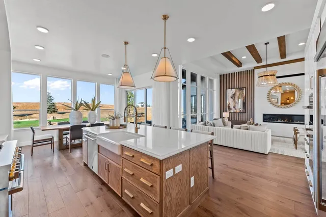 a kitchen with stainless steel appliances granite countertop a stove and a wooden floors