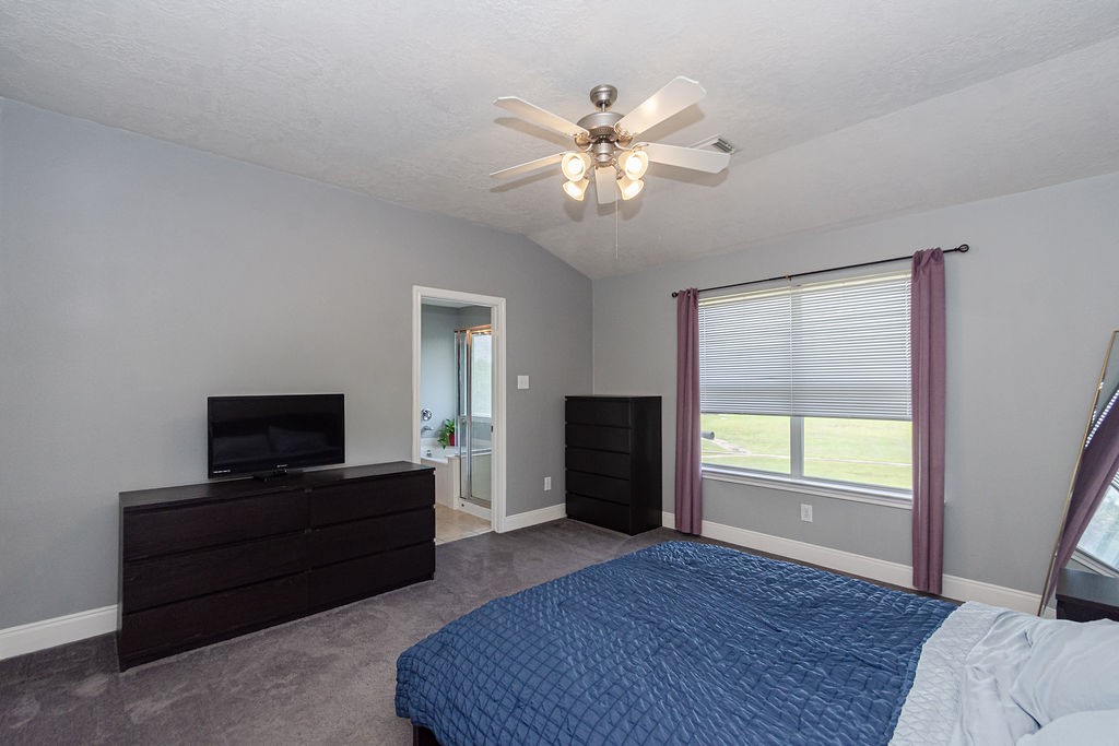 242 Drake Run Lane Dickinson, TX 77539 - Photo 11 of 18 a living room with furniture and a flat screen tv