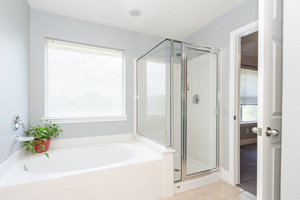 242 Drake Run Lane Dickinson, TX 77539 - Photo 14 of 18 a white bath tub sitting next to a shower