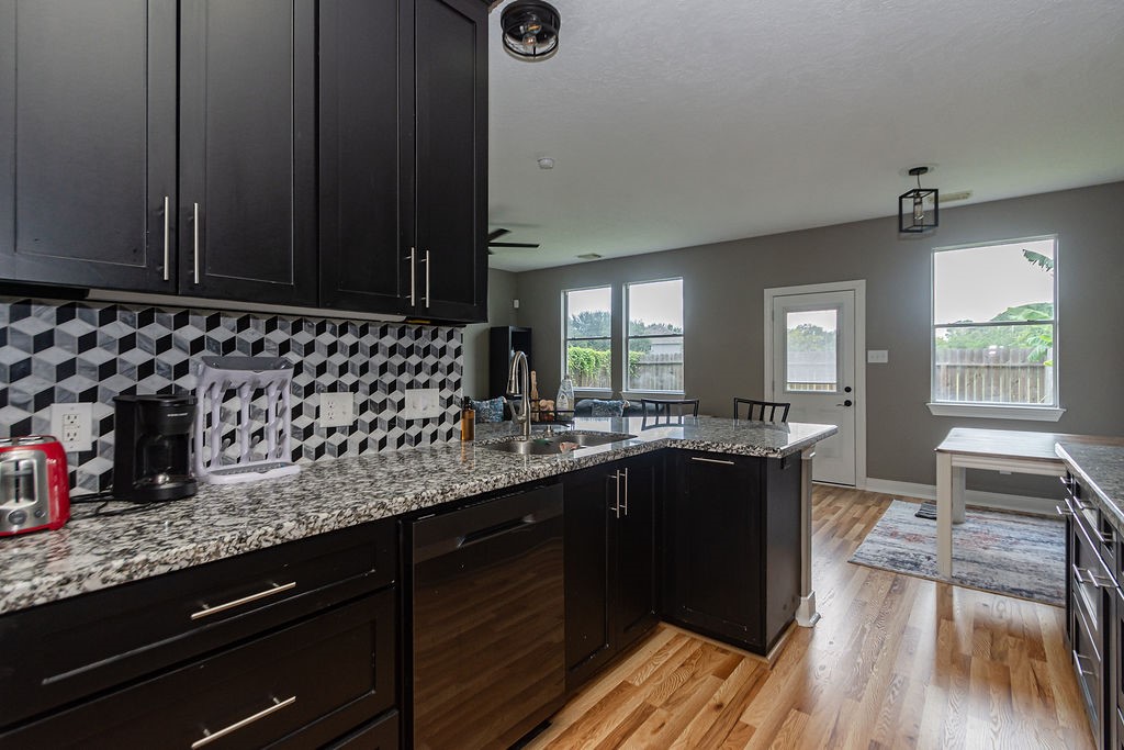 242 Drake Run Lane Dickinson, TX 77539 - Photo 7 of 18 a kitchen with a sink and wooden cabinets