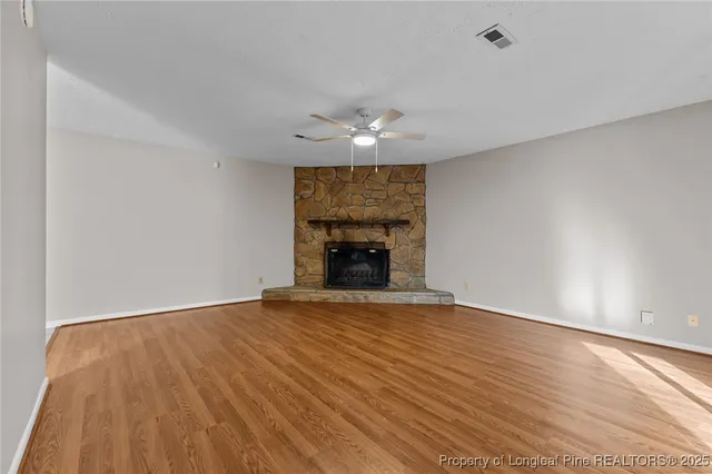 wooden floor in an empty room with a fireplace