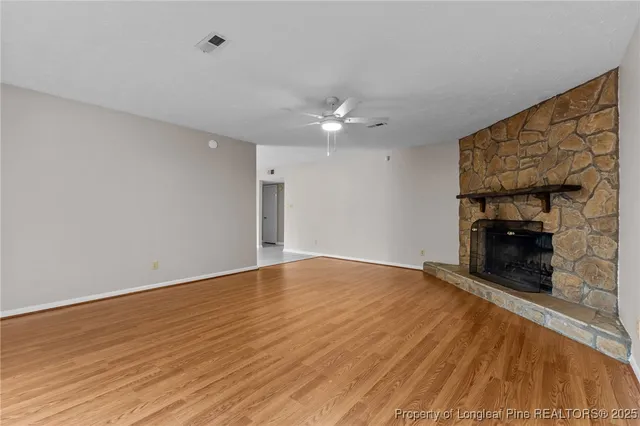 wooden floor in an empty room with a fireplace
