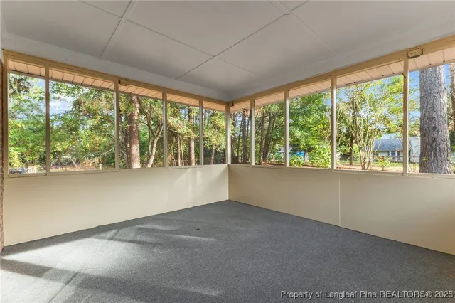 an empty room with large windows