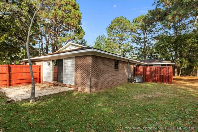 a backyard of a house with table and chairs