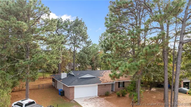 a view of a backyard with a tree