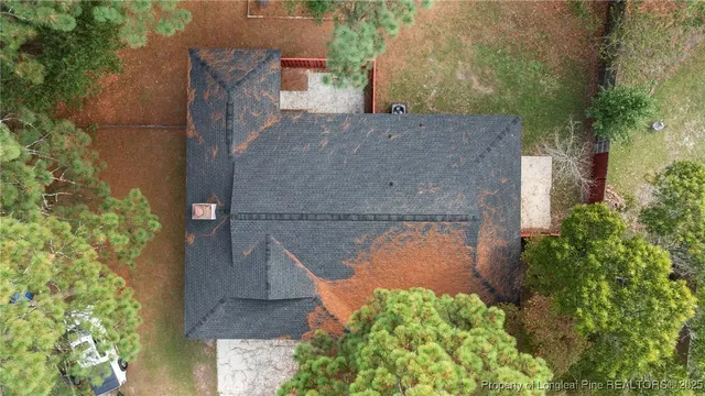 an aerial view of a house with a yard