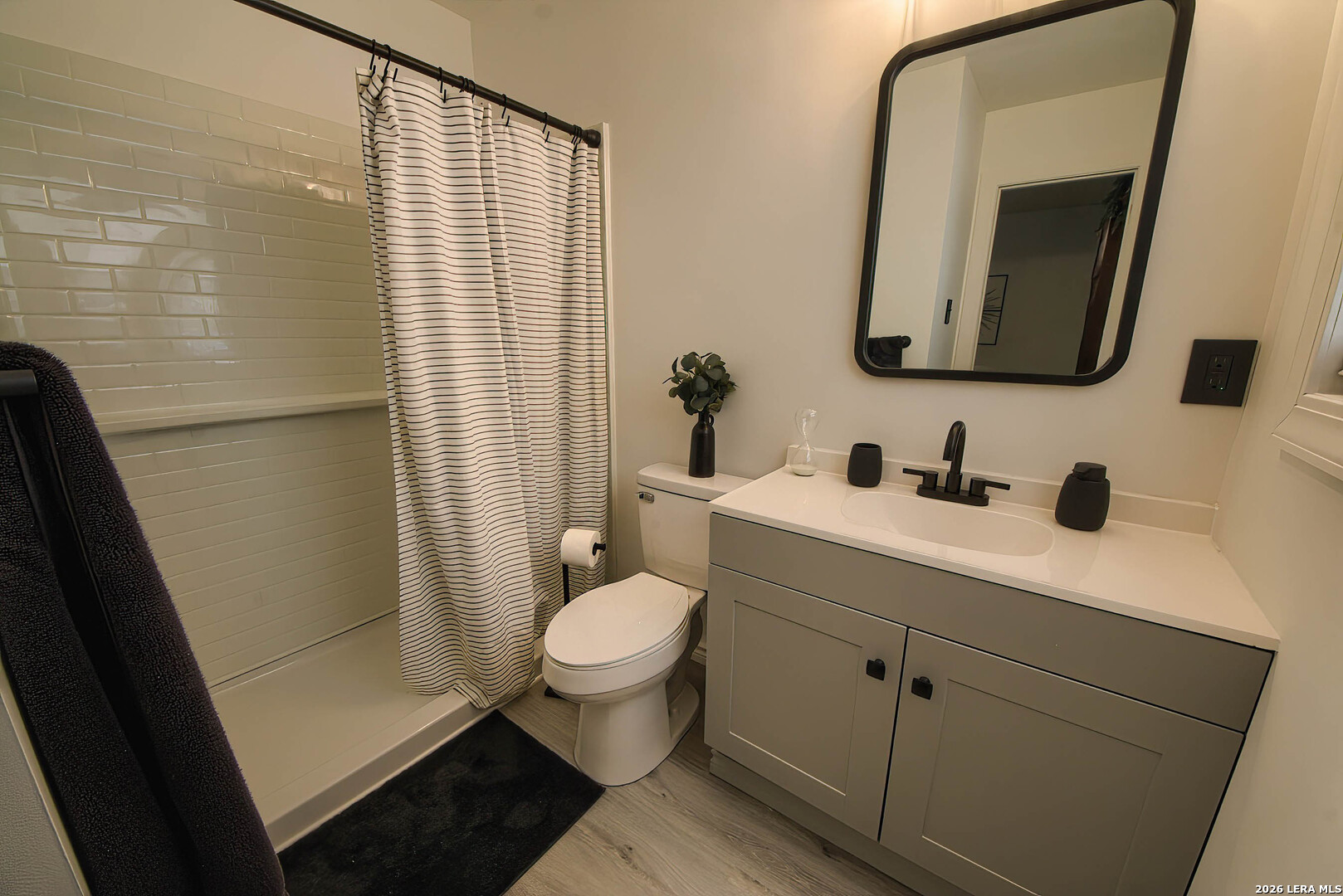 3909 McCall Creek Road Blanco, TX 78606 - Photo 15 of 55 a bathroom with a toilet sink vanity shower and mirror