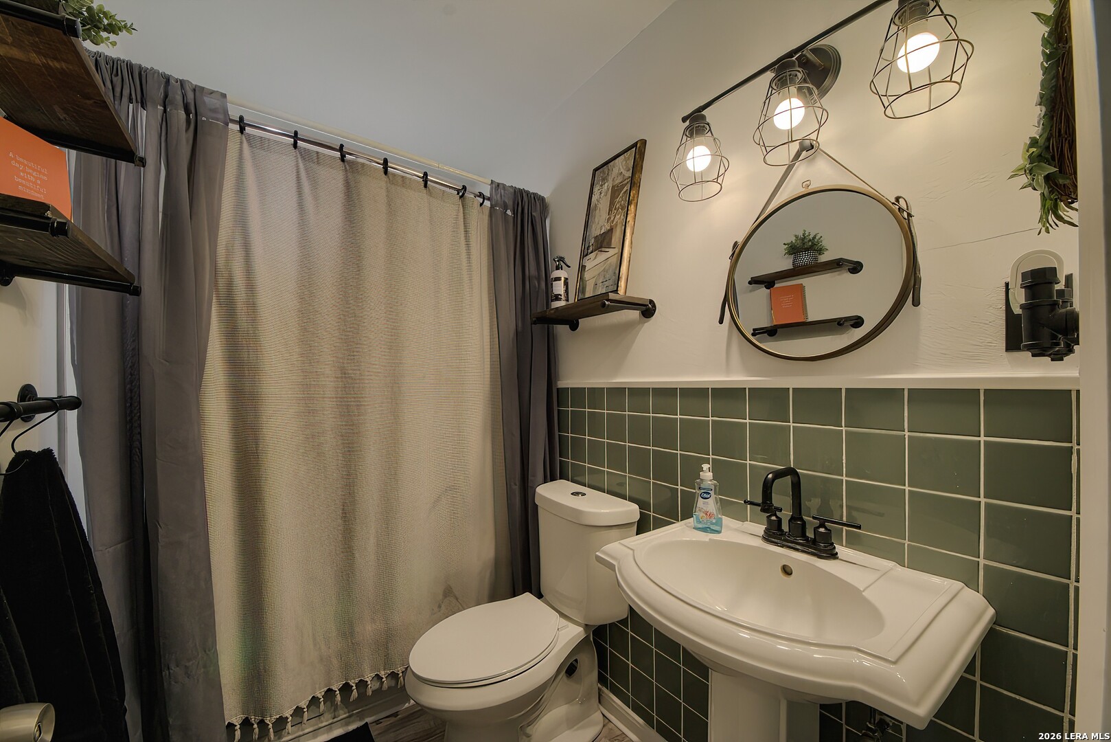 3909 McCall Creek Road Blanco, TX 78606 - Photo 22 of 55 a bathroom with a toilet a sink and a mirror