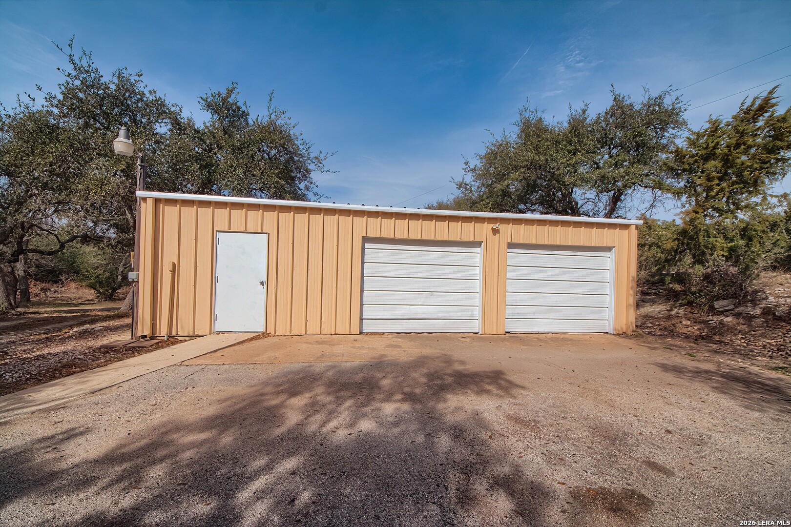 3909 McCall Creek Road Blanco, TX 78606 - Photo 37 of 55 a backyard of a house with garage