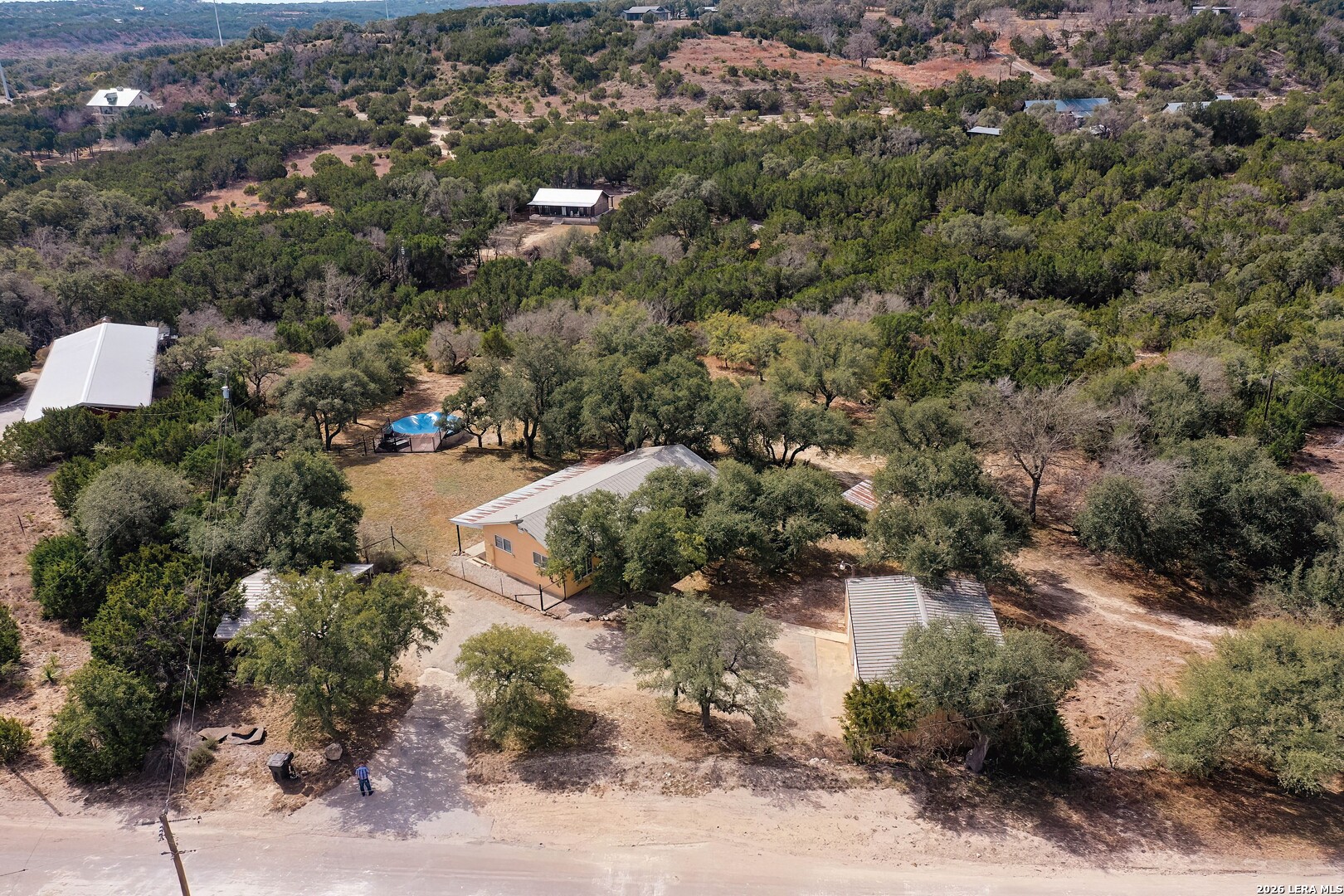 3909 McCall Creek Road Blanco, TX 78606 - Photo 50 of 55 an aerial view of residential house with outdoor space and trees all around