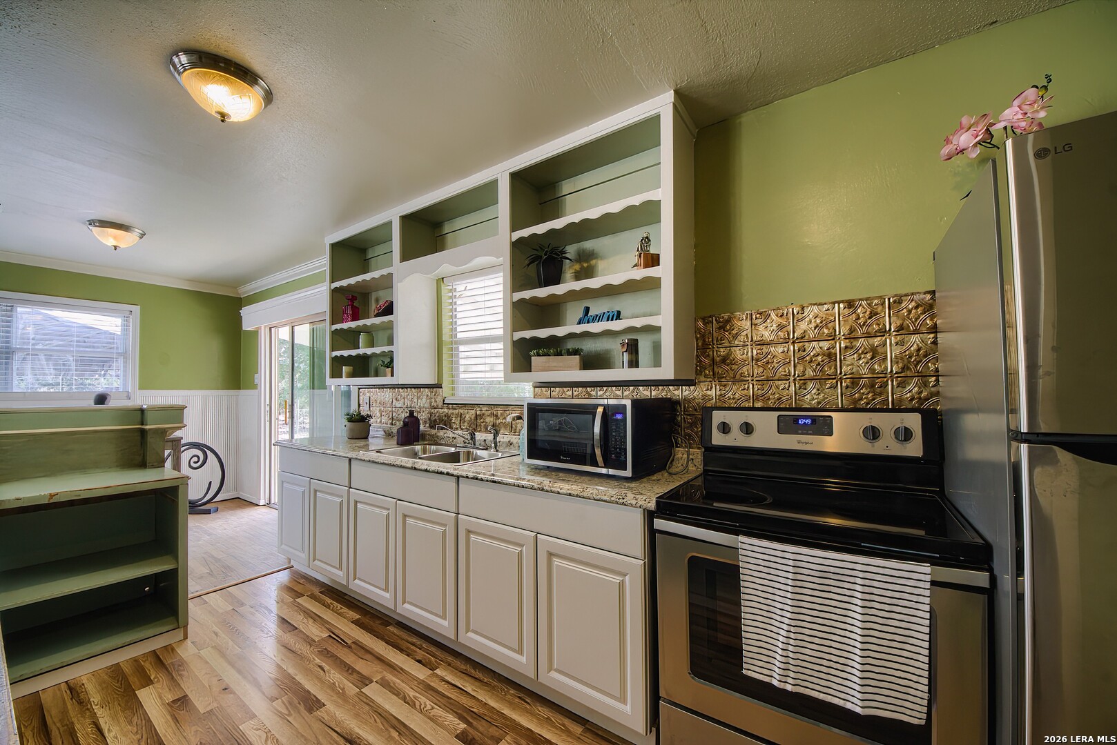 3909 McCall Creek Road Blanco, TX 78606 - Photo 10 of 55 a kitchen with stainless steel appliances a stove a sink and a refrigerator