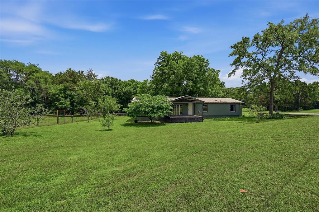 150 Gilbreath Road Sadler, TX 76264 - Photo 1 of 34 a front view of a house with a garden