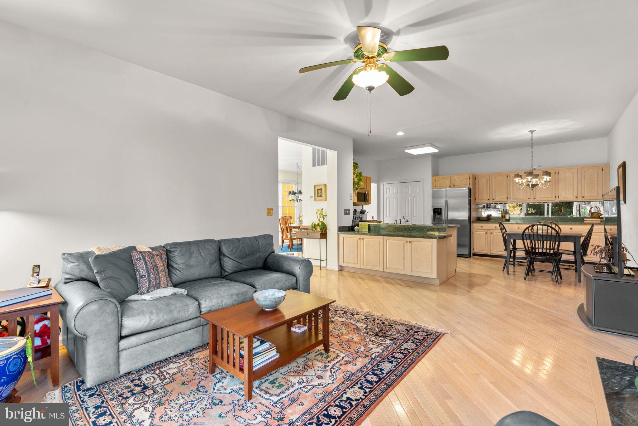 5161 Harpers Farm Road, Unit 27 Columbia, MD 21044 - Photo 12 of 55 a living room with furniture kitchen view and a chandelier
