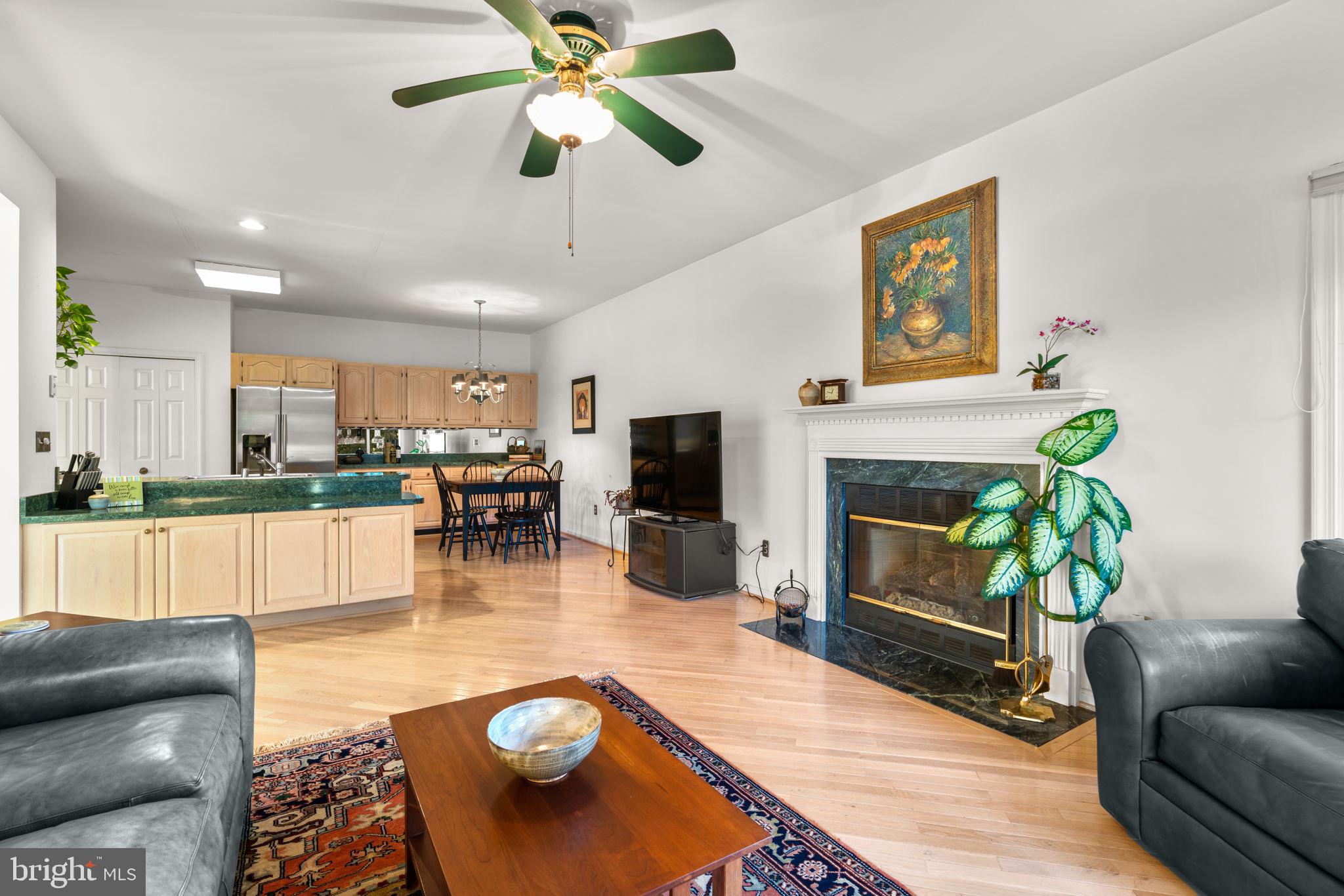 5161 Harpers Farm Road, Unit 27 Columbia, MD 21044 - Photo 13 of 55 a living room with furniture and a fireplace