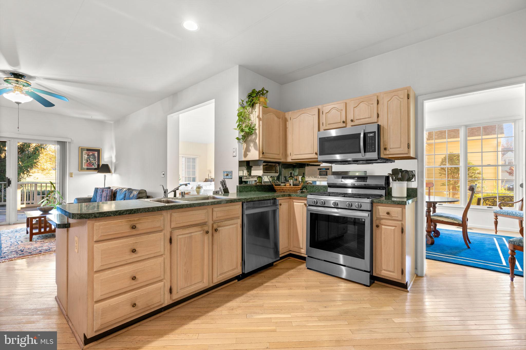 5161 Harpers Farm Road, Unit 27 Columbia, MD 21044 - Photo 15 of 55 a kitchen with stainless steel appliances granite countertop a stove and a sink