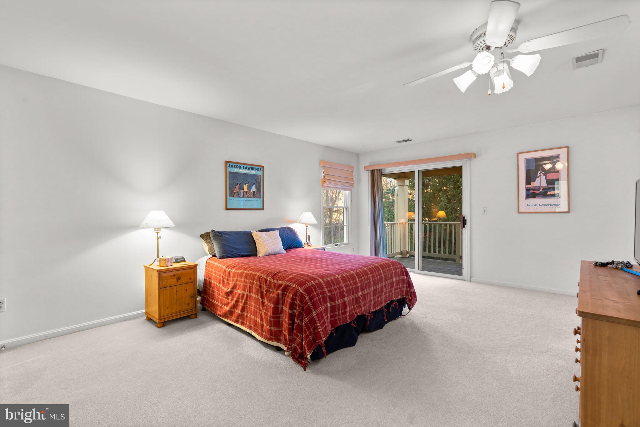 5161 Harpers Farm Road, Unit 27 Columbia, MD 21044 - Photo 20 of 55 a bedroom with a bed and a chandelier