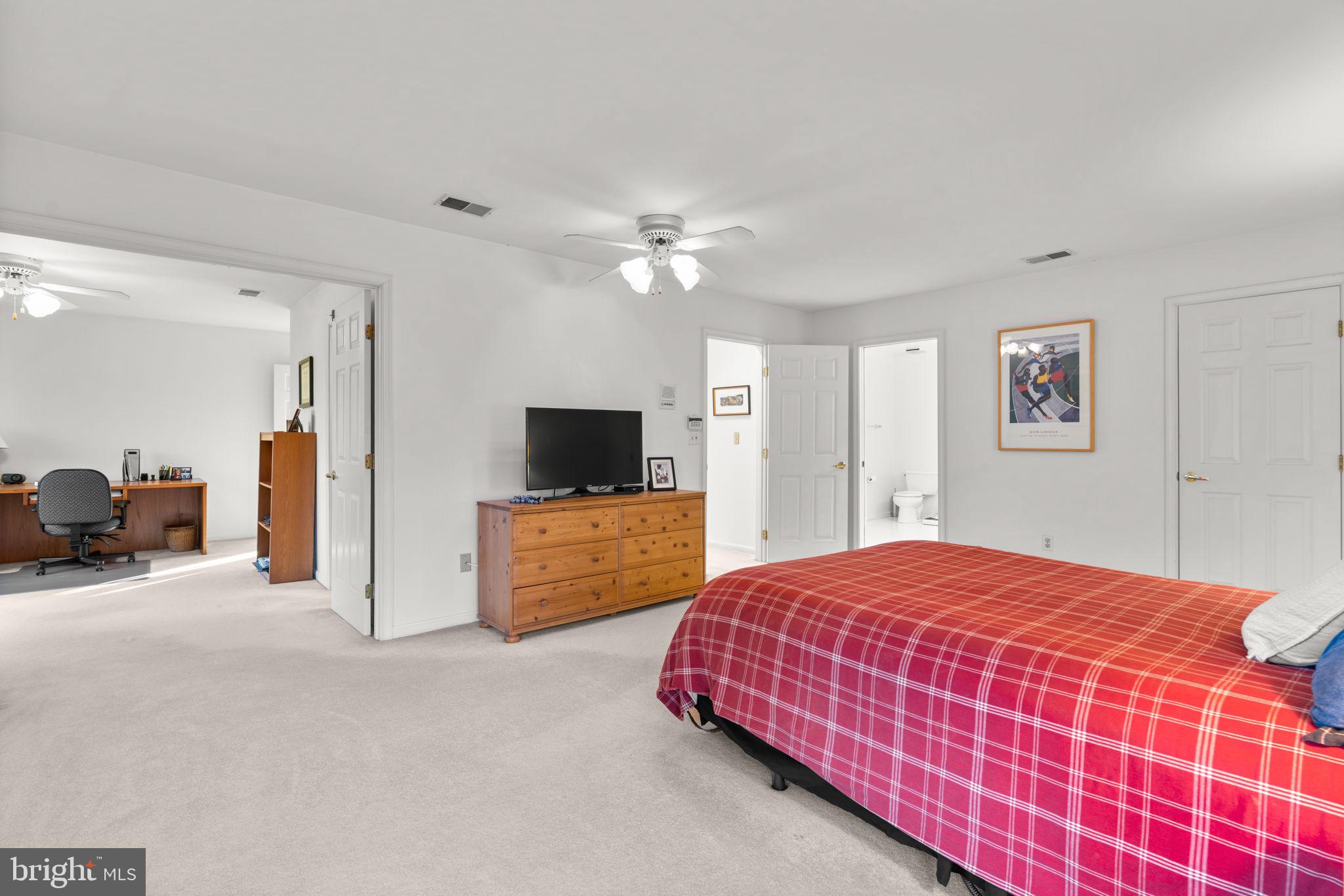 5161 Harpers Farm Road, Unit 27 Columbia, MD 21044 - Photo 21 of 55 a bedroom with a bed and a flat screen tv