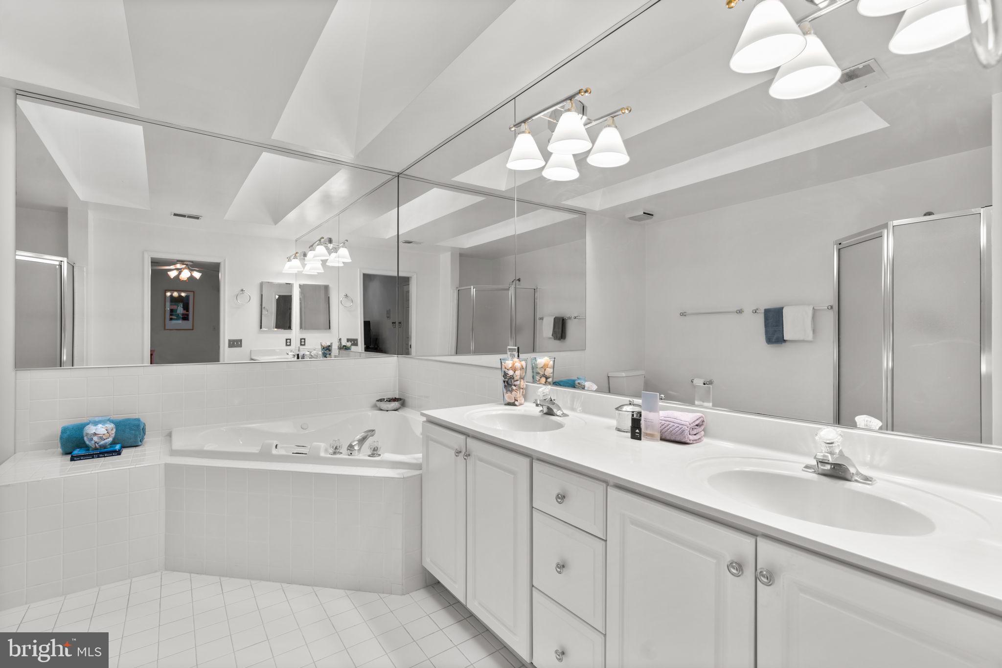 5161 Harpers Farm Road, Unit 27 Columbia, MD 21044 - Photo 22 of 55 a bathroom with a double vanity sink and a mirror