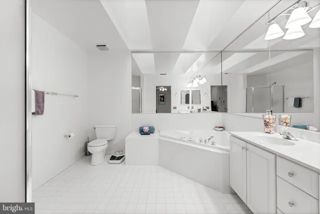 a spacious bathroom with a sink mirror vanity and toilet