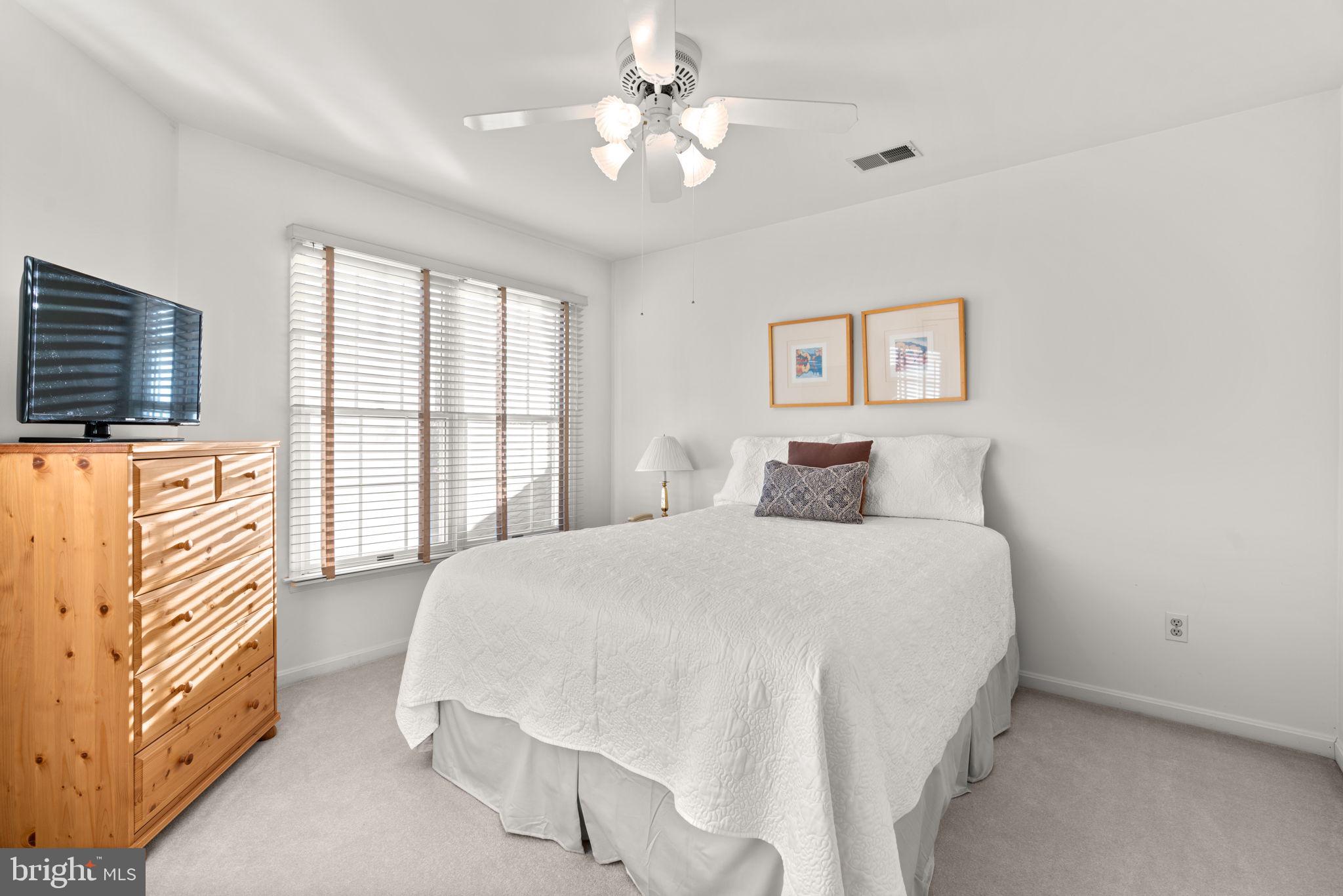 5161 Harpers Farm Road, Unit 27 Columbia, MD 21044 - Photo 27 of 55 a bedroom with a bed and a flat screen tv