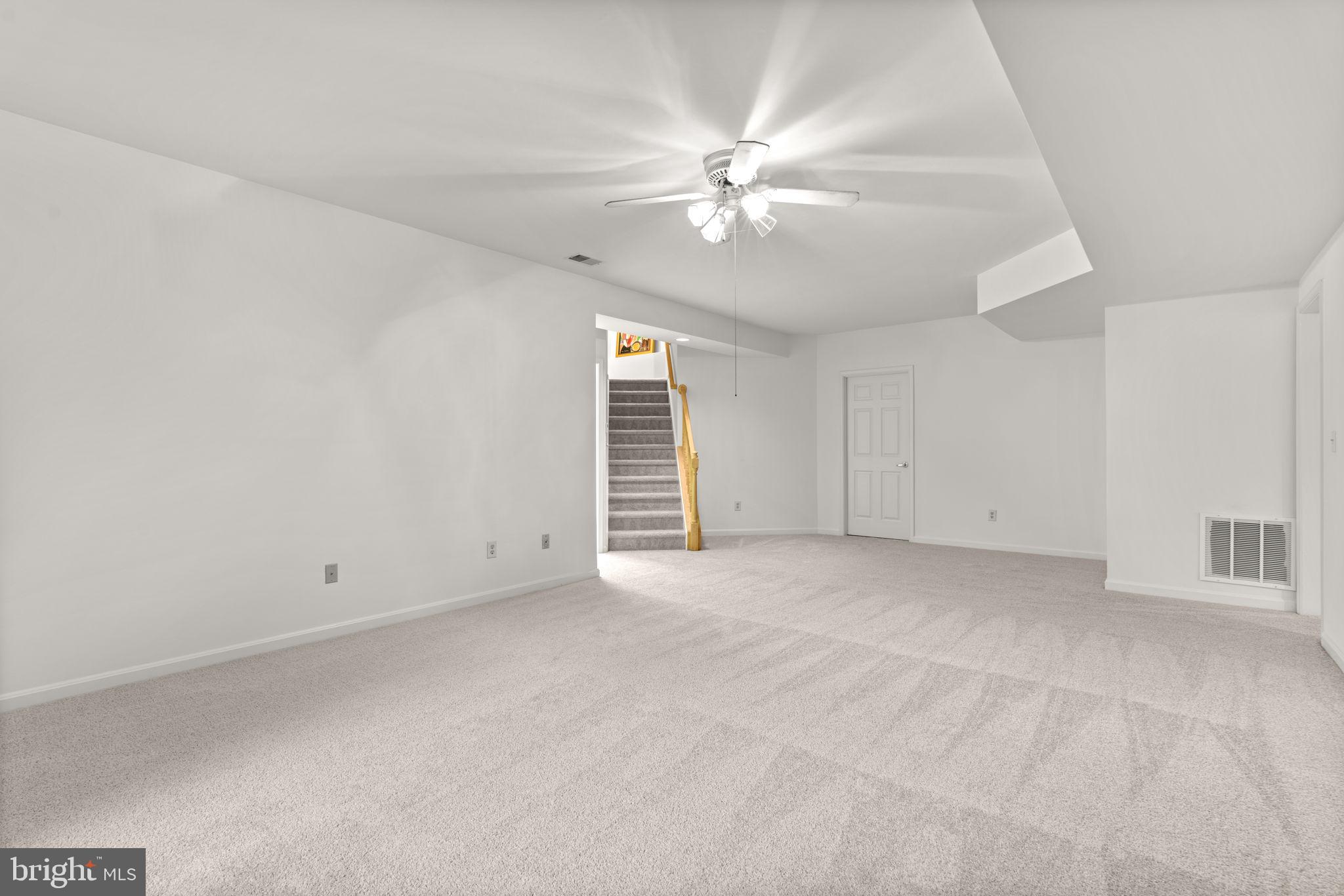 5161 Harpers Farm Road, Unit 27 Columbia, MD 21044 - Photo 35 of 55 a view of an empty room with a ceiling fan